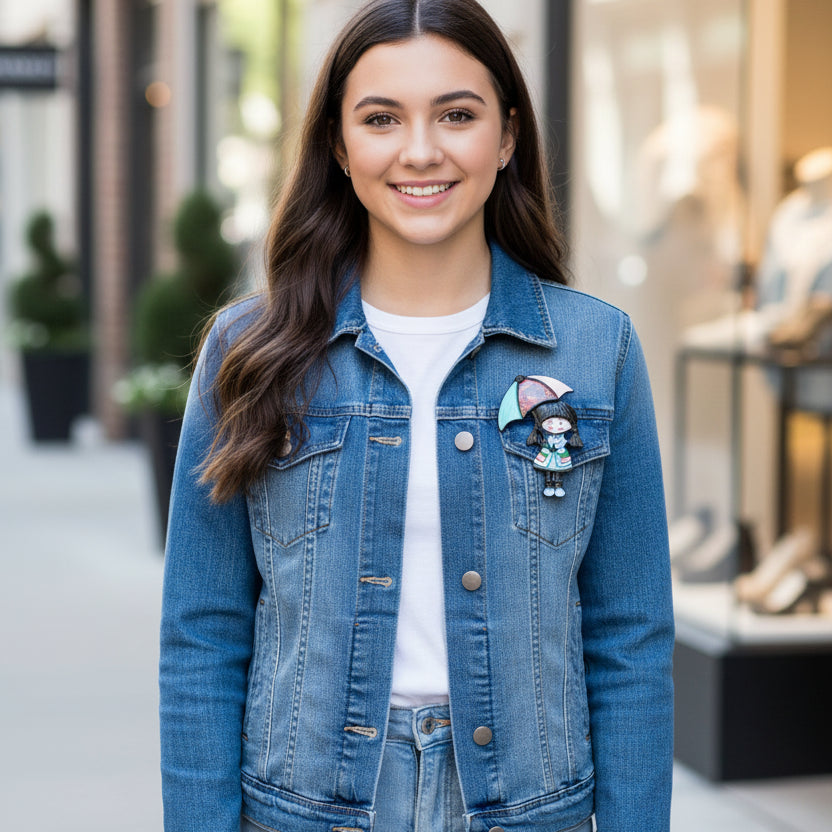 Colorful brooch of a girl with an umbrella, pinned on a denim jacket