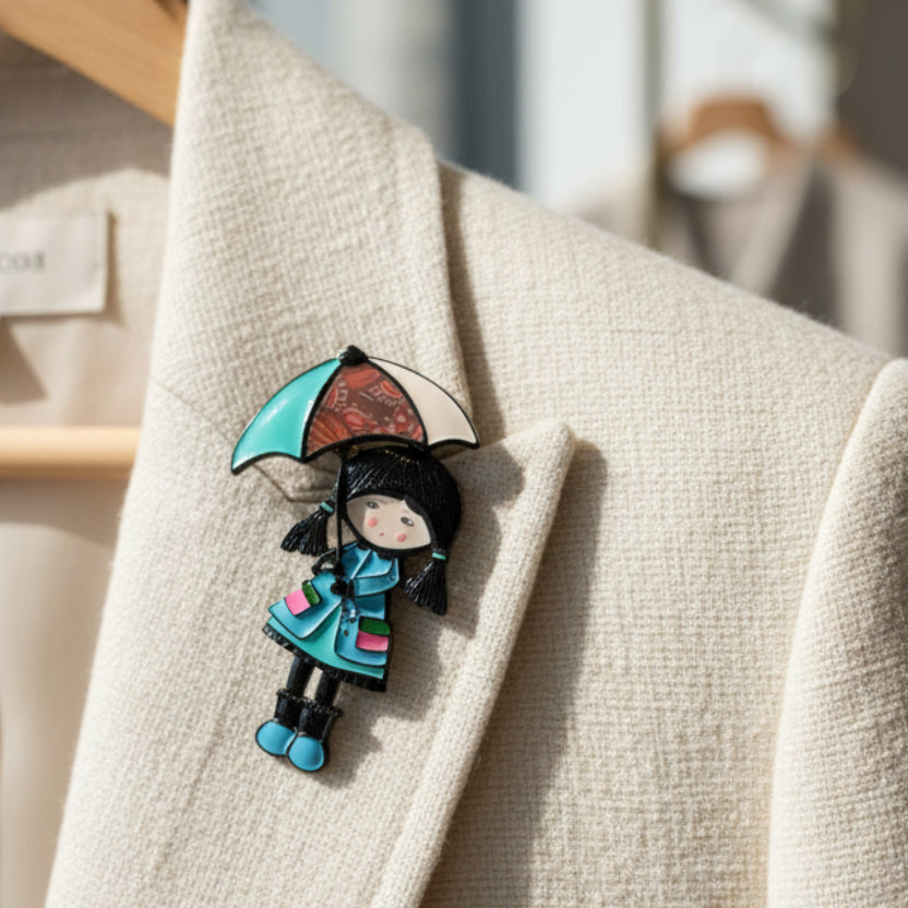 Colorful brooch of a girl with an umbrella on a textured surface