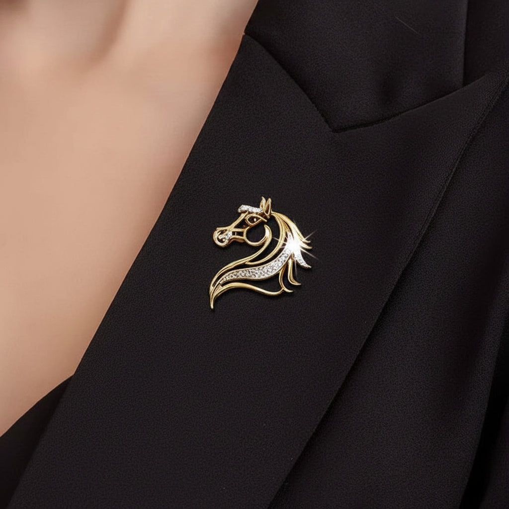 Gold horse head silhouette brooch with gemstones pinned on a black suite