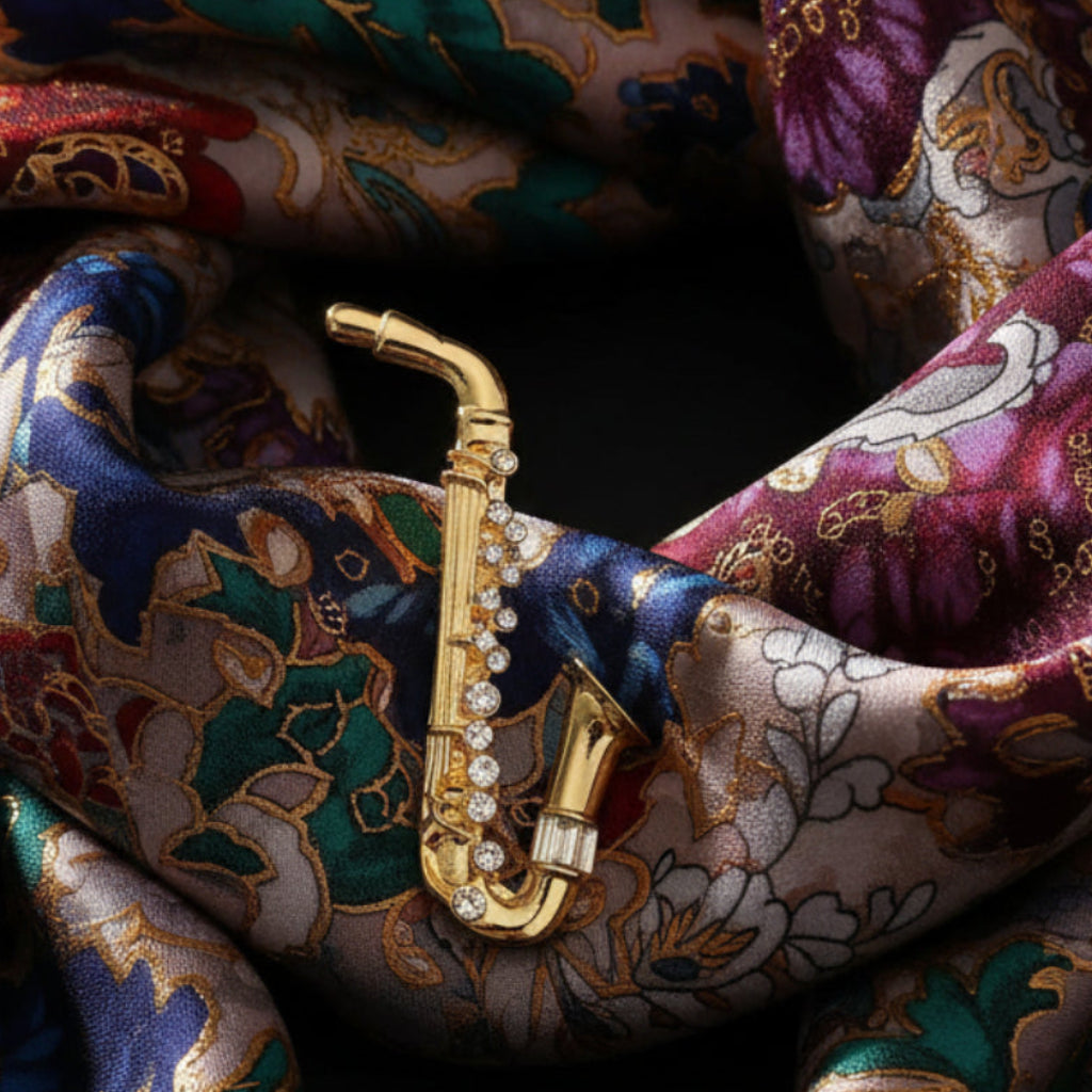 Gold saxophone-shaped brooch on a colorful background