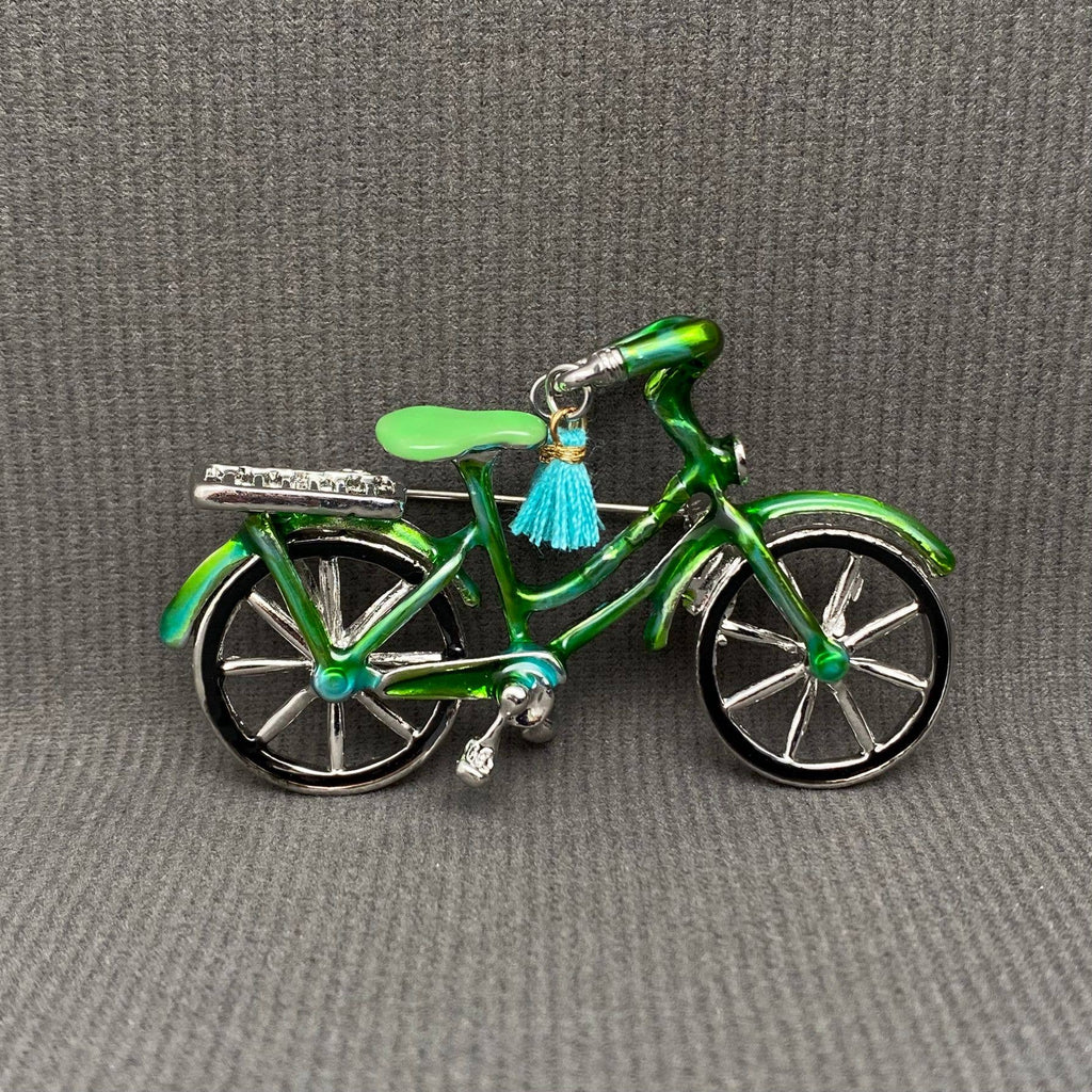 Green enamel bicycle-shaped brooch with blue tassel handle bars