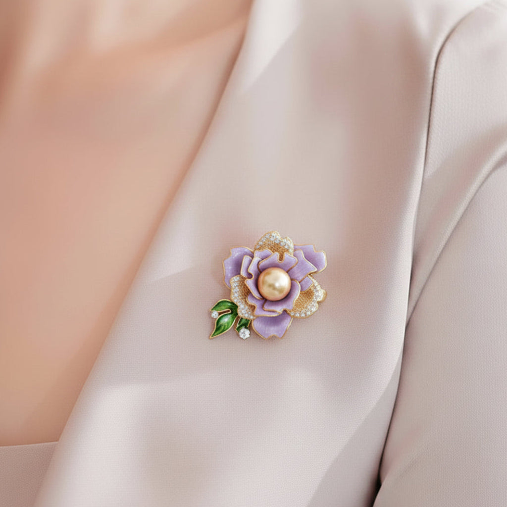 Lavender flower-shaped brooch with a pearl center pinned on a white dress