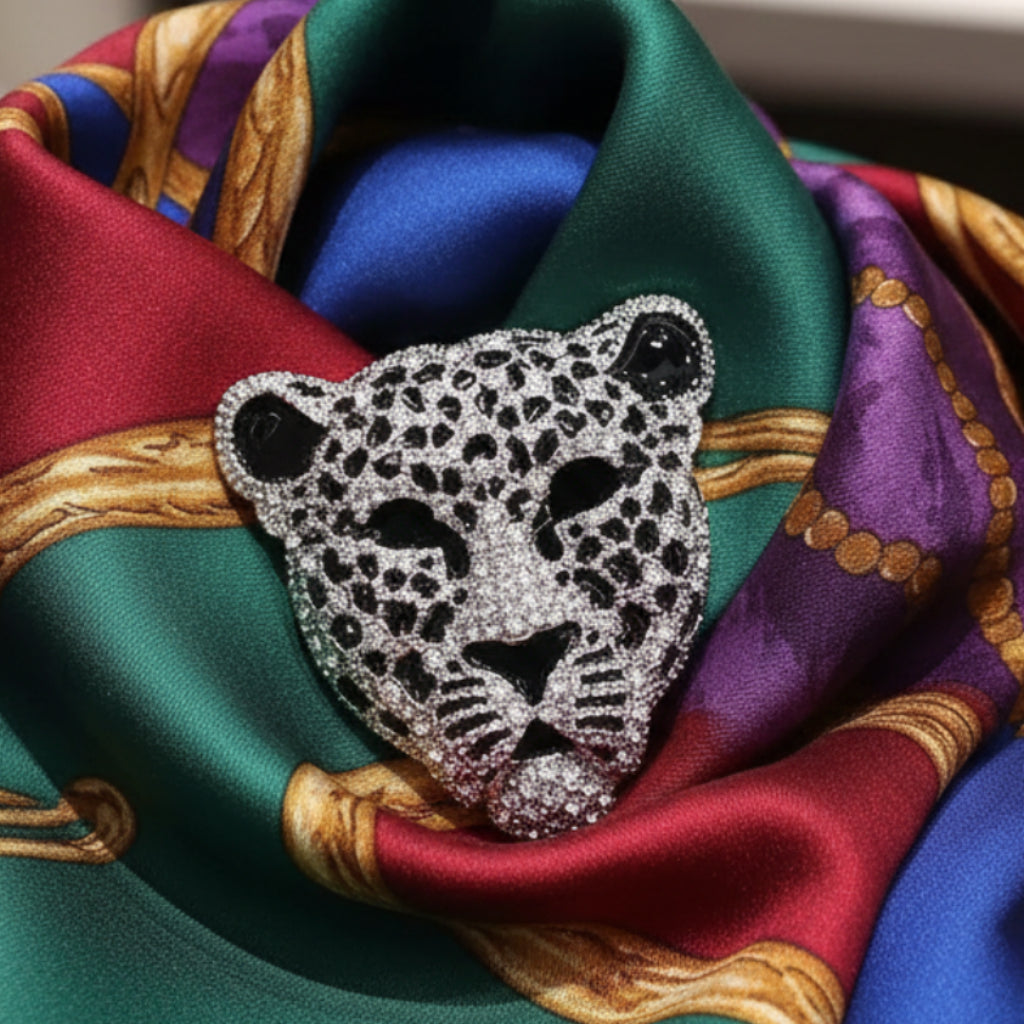Leopard head rhinestone brooch on a colorful silk scarf