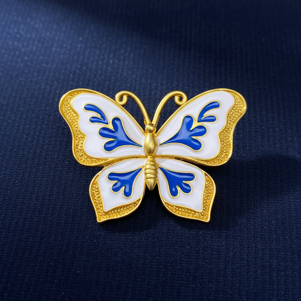 Butterfly-shaped brooch with blue and gold design on a blue background