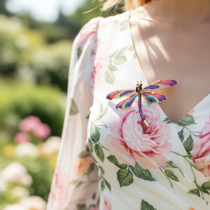 Colorful dragonfly-shaped brooch pinned on a floral dress