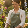 Dandelion brooch with pearl-like accents pinned on a woman's green apron