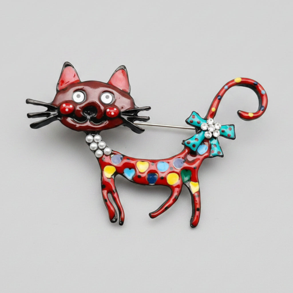 Colorful cat-shaped brooch on a gray background