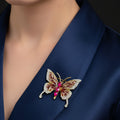 Butterfly-shaped brooch with gemstones on a dark background