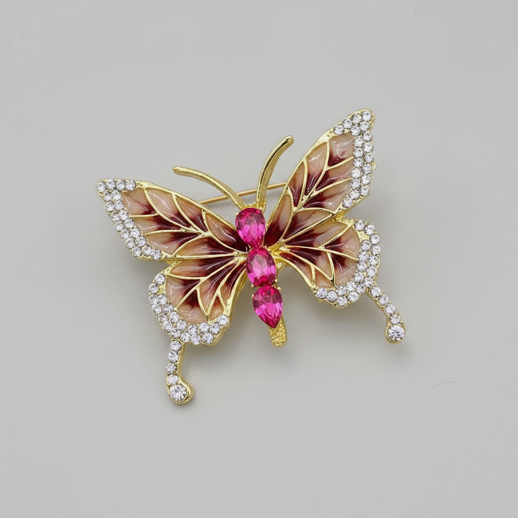 Butterfly-shaped brooch with gemstones on a light background
