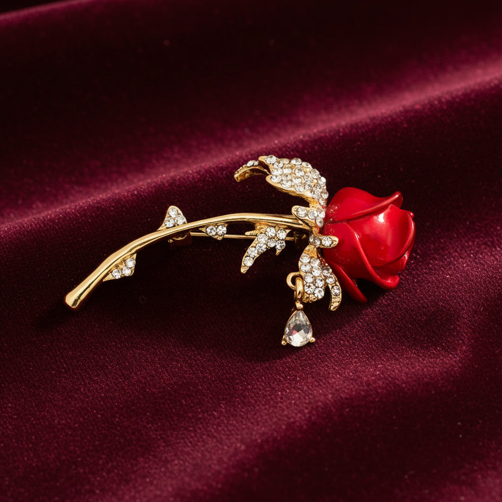 Gold brooch with a red rose on a maroon background