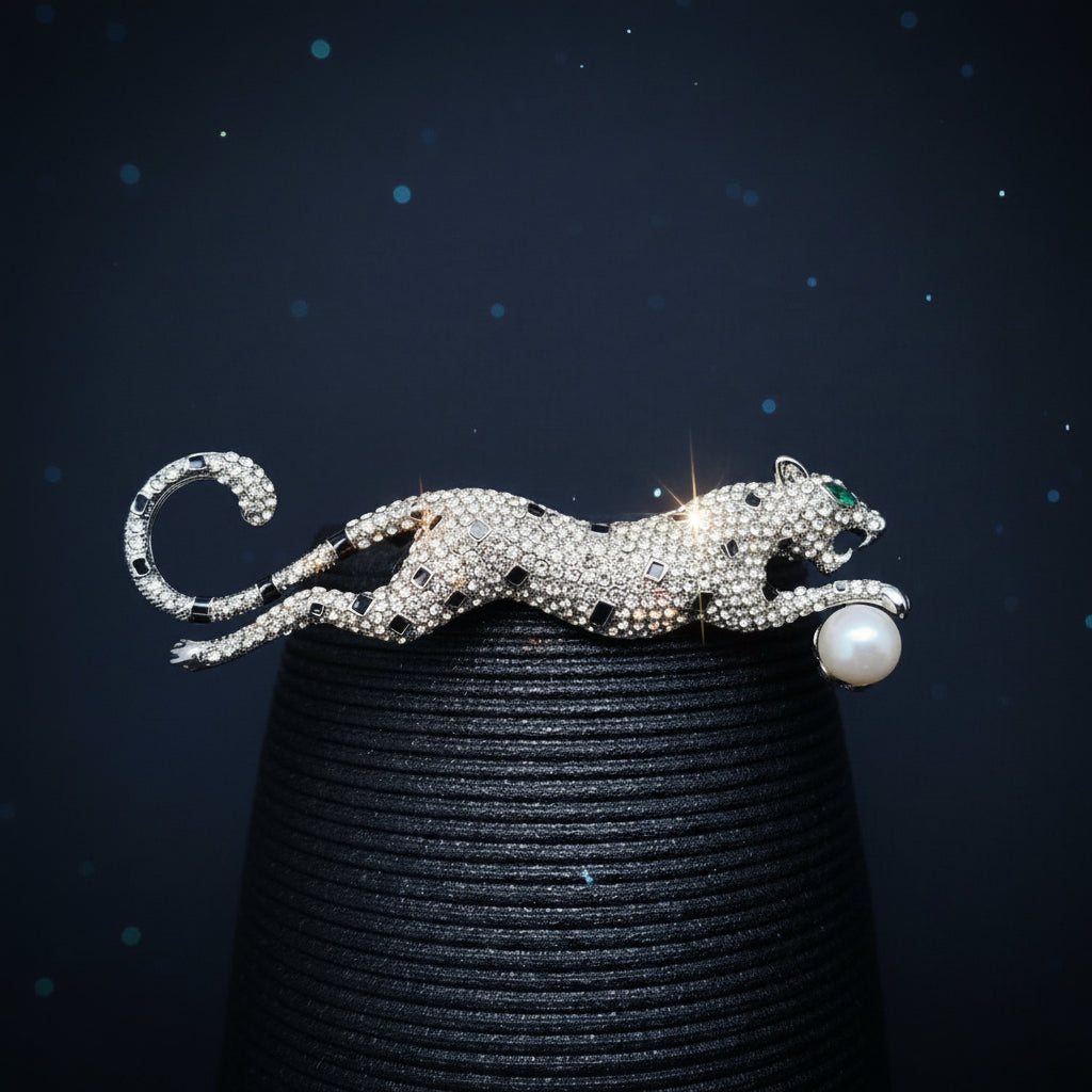 Rhinestone cheetah brooch with green crystal eyes and faux pearl accent in silver-tone finish