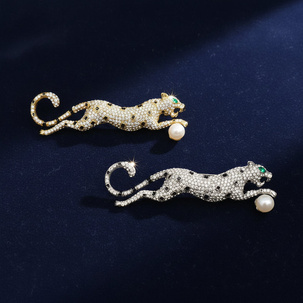 Rhinestone cheetah brooch with green crystal eyes and faux pearl accent in silver-tone and gold-tone finishes
