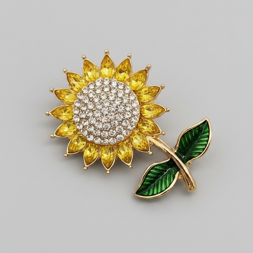 Sunflower-shaped brooch with rhinestones on a gray background