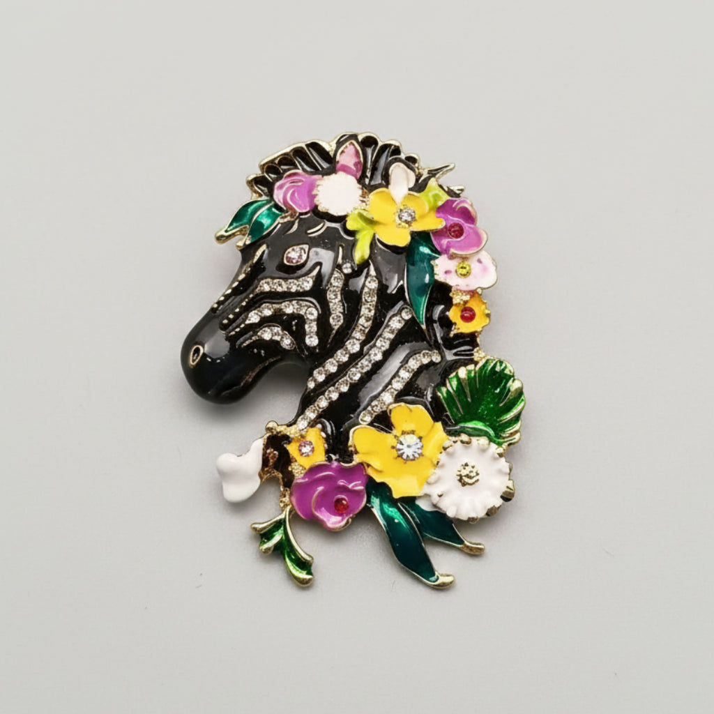 Decorative zebra brooch with flowers on a gray background