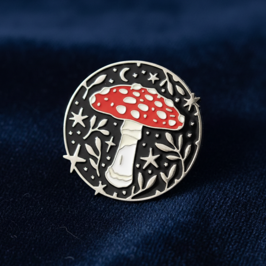 Round mushroom enamel pin with red cap and silver woodland design