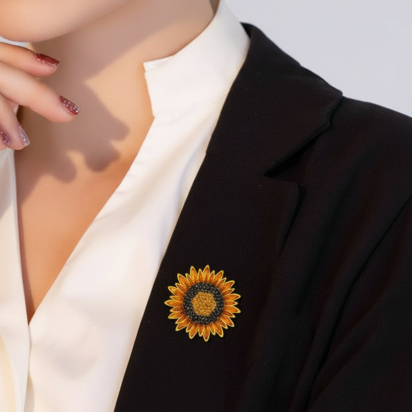 Sunflower-shaped brooch with gold petals and gemstone center pinned  on a woman's black suite
