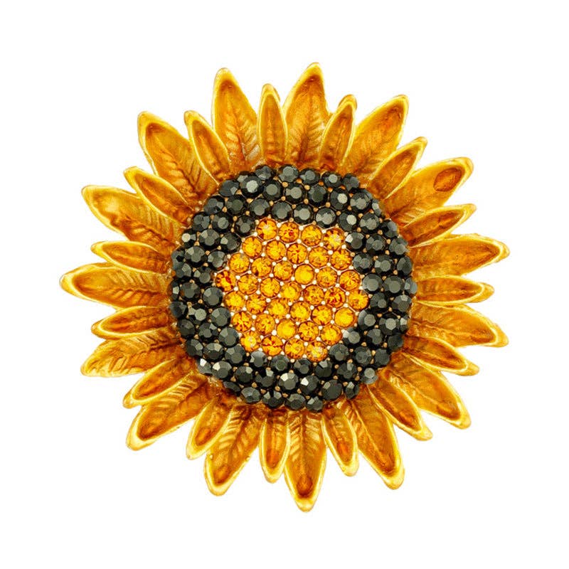Sunflower-shaped brooch with gold petals and gemstone center on a white background