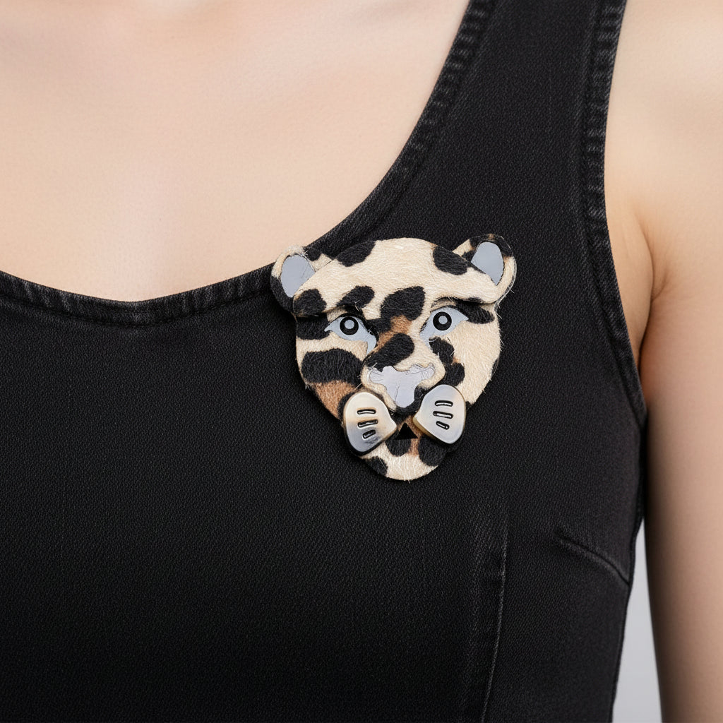 Textured acrylic leopard shaped brooch on a black background