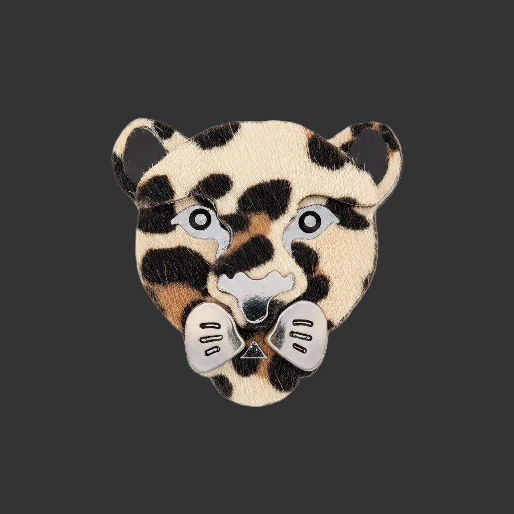 Textured acrylic leopard shaped brooch on a black background