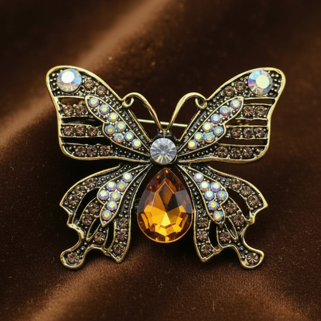 Butterfly-shaped brooch with gemstones on a brown background