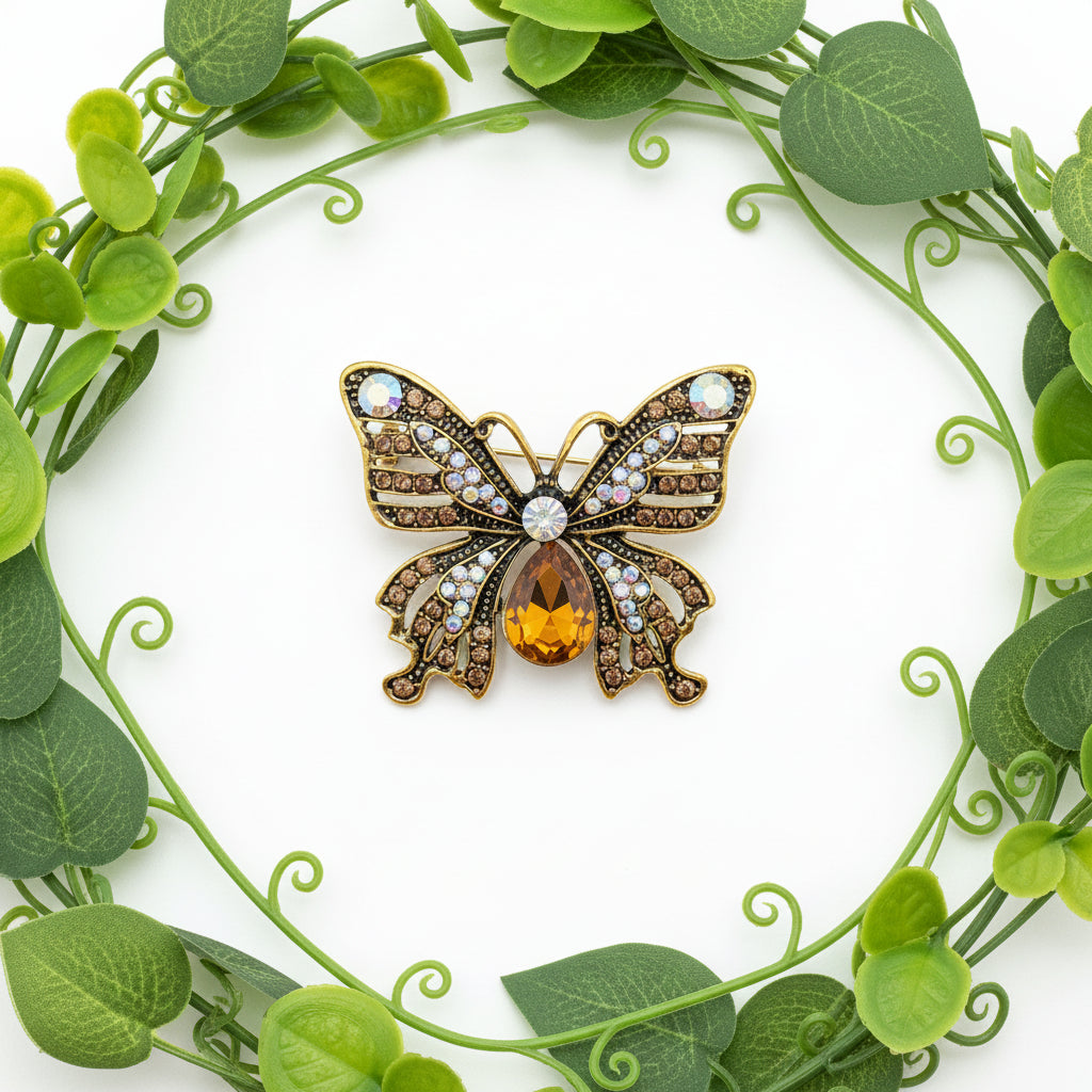 Butterfly-shaped brooch with gemstones on a white background