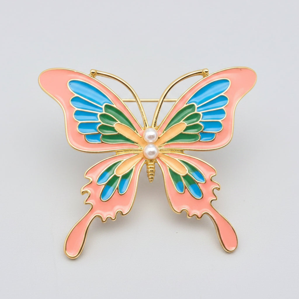 Butterfly-shaped brooch with pink, blue, and green wings on a white background