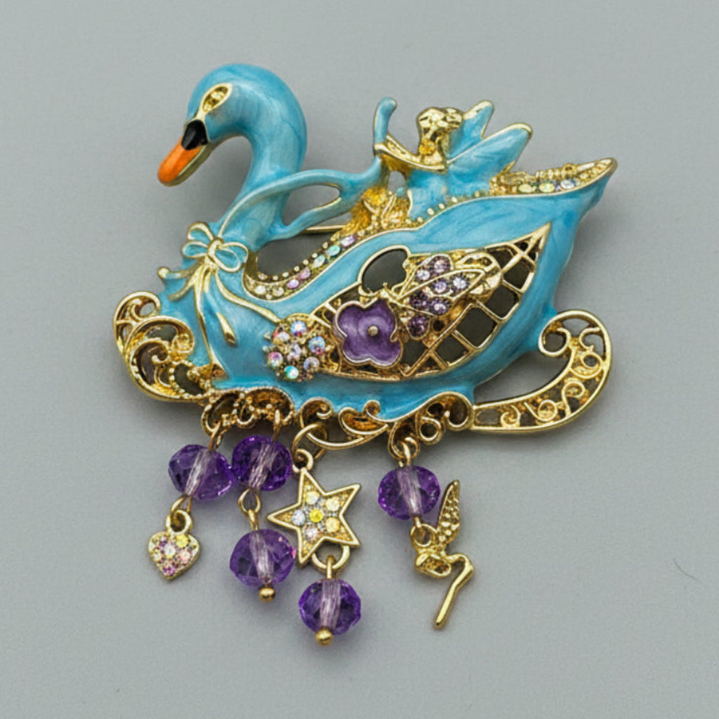 Decorative brooch shaped like a swan with gold and purple accents on a gray background