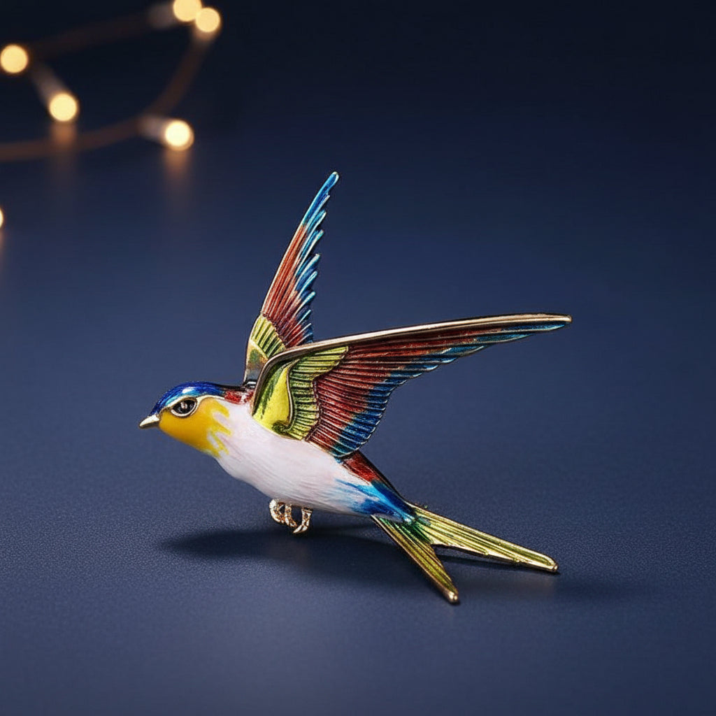 A colorful enamel bird brooch shaped like a flying swallow, featuring blue, green, and yellow, with gold-tone metal accents, on a blue background